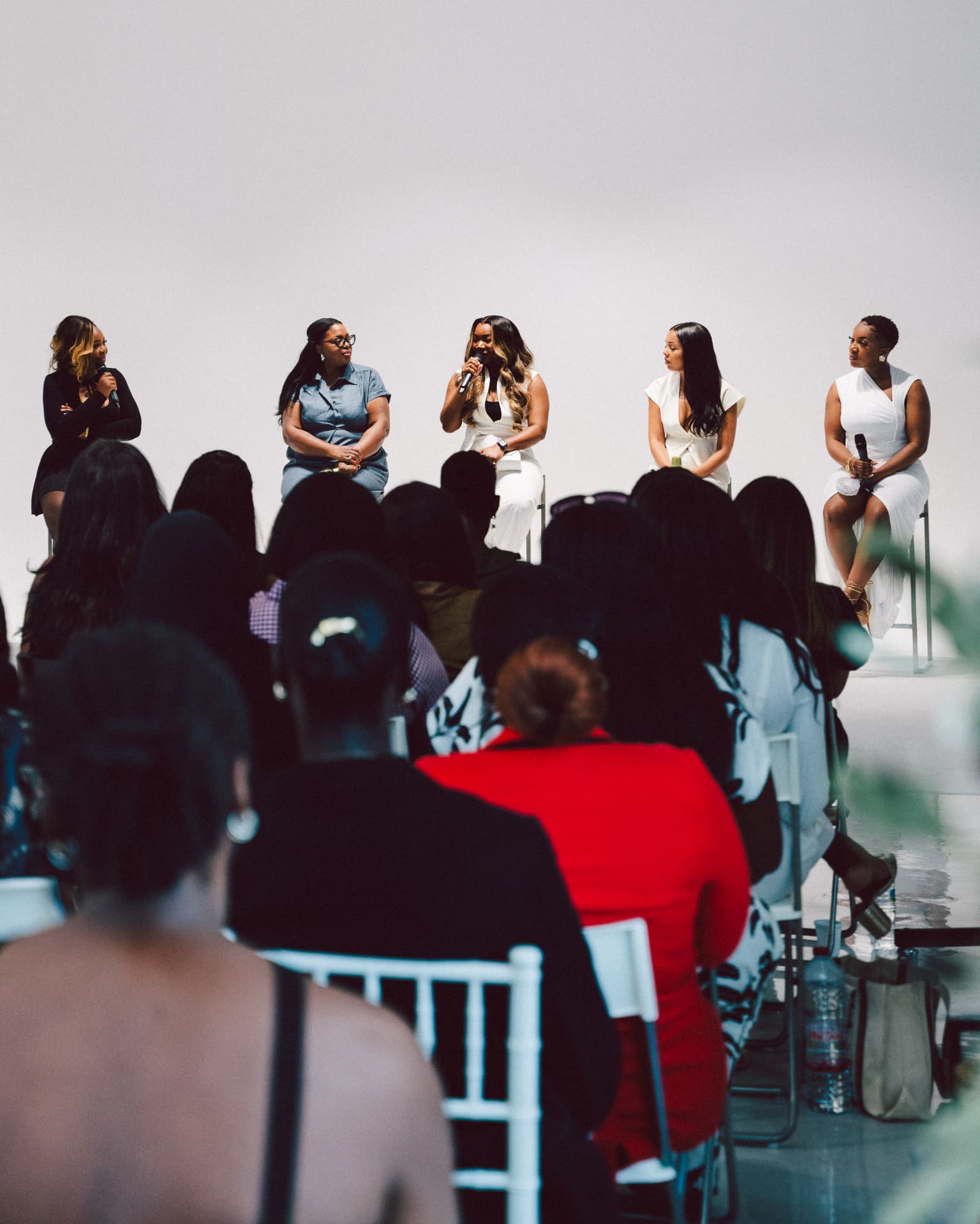 Panel of founders speaking to a full audience at an Elite Business Academy event